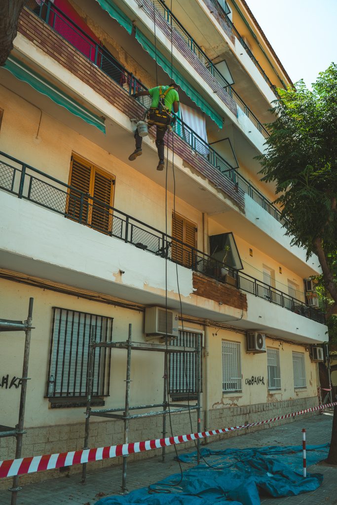 Operario realizando trabajos en altura en una fachada